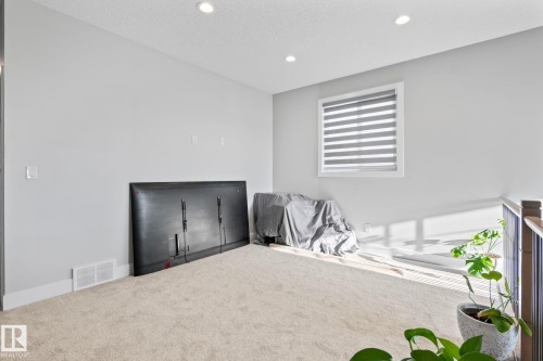 Carpeted flooring, recessed lighting, white trim, and a window with blinds - 824 34 Ave Nw, Edmonton, AB 