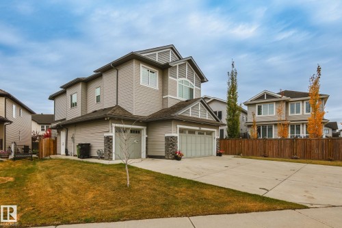 Multi-level exterior with light gray siding and stone accents - 824 34 Ave Nw, Edmonton, AB 