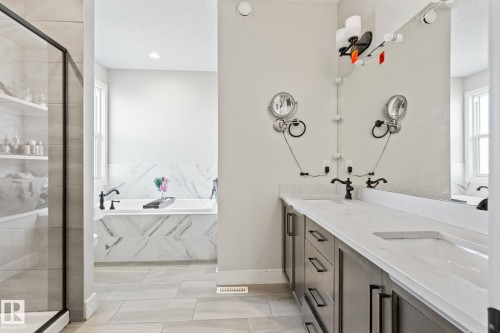 Dual vanity with undermount sinks, quartz countertops, and dark-finish cabinetry - 824 34 Ave Nw, Edmonton, AB 