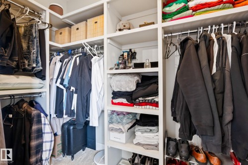 Built-in closet system with multiple hanging rods and shelving - 824 34 Ave Nw, Edmonton, AB 