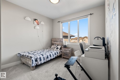 Carpeted flooring, a window with multiple panes, and a flush mount ceiling light - 824 34 Ave Nw, Edmonton, AB 