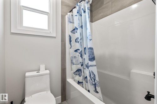 White-framed window and a white toilet - 824 34 Ave Nw, Edmonton, AB 