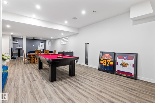 Expansive open-concept room featuring wood-finish flooring, recessed lighting, and a white ceiling - 824 34 Ave Nw, Edmonton, AB 