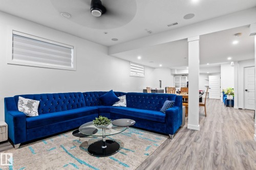 Recessed lighting, wood-finish flooring, white walls, architectural column, and contemporary window blind - 824 34 Ave Nw, Edmonton, AB 