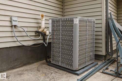 Siding exterior with a visible air conditioning unit - 824 34 Ave Nw, Edmonton, AB 