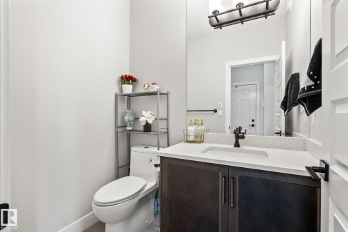 Dark wood-finish vanity with a light-toned countertop - 824 34 Ave Nw, Edmonton, AB 