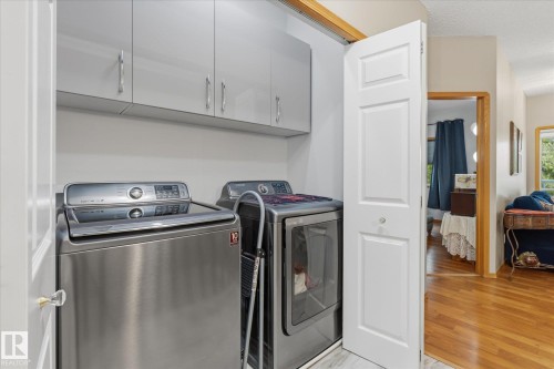 Built-in gray cabinetry with chrome hardware - 7 Linkside Pl, Spruce Grove, AB 