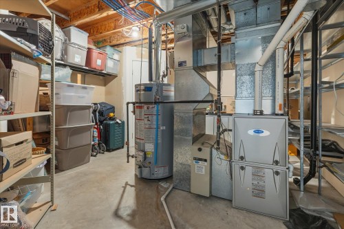 Concrete flooring in a utility space featuring a water heater and furnace system - 7 Linkside Pl, Spruce Grove, AB 