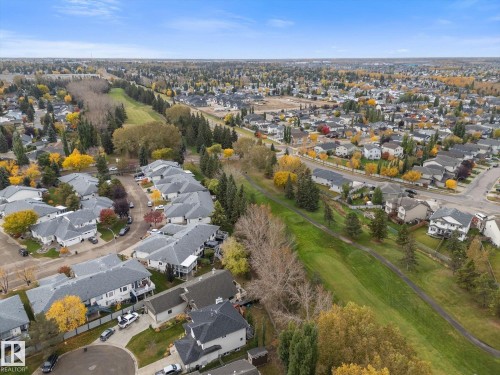 Residential neighborhood featuring varied rooflines, mature trees, and extensive green spaces with walking paths - 7 Linkside Pl, Spruce Grove, AB 