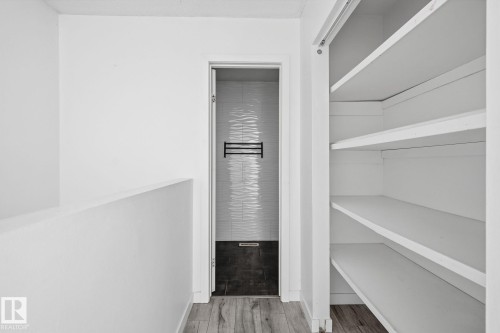 White walls with wood-finish flooring - 164 Dickinsfield Court Nw, Edmonton, AB 