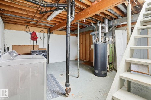 Exposed ceiling joists, concrete flooring, and an open staircase - 164 Dickinsfield Court Nw, Edmonton, AB 