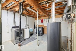 Exposed wood beam ceiling, concrete flooring, and utility sink - 