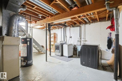 Finished basement space featuring exposed wood joists and concrete flooring - 164 Dickinsfield Court Nw, Edmonton, AB 