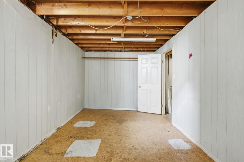 Vertical paneling on walls with exposed ceiling joists - 164 Dickinsfield Court Nw, Edmonton, AB 