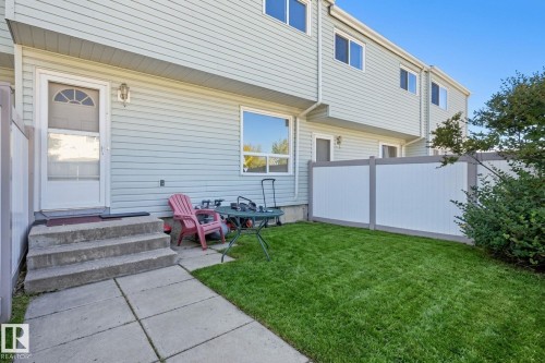 Private outdoor space with a manicured lawn, concrete patio, and privacy fencing - 164 Dickinsfield Court Nw, Edmonton, AB 