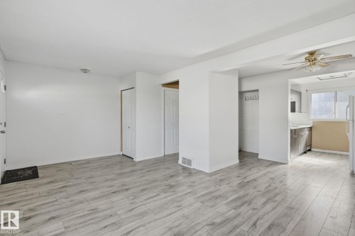 Wood-finish flooring, white walls, and a ceiling fan with integrated lighting - 164 Dickinsfield Court Nw, Edmonton, AB 