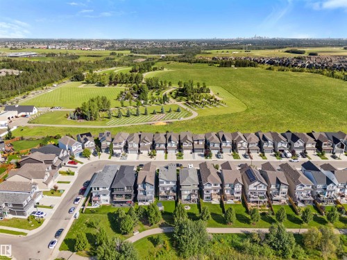 Residential area with established homes, green spaces, and a distant urban skyline - 3334 Parker Loop Sw, Edmonton, AB 