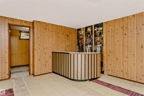 Wood-paneled walls and ceiling, with a built-in counter featuring vertical slat detailing - 11440 44A Avenue Nw, Edmonton, AB 