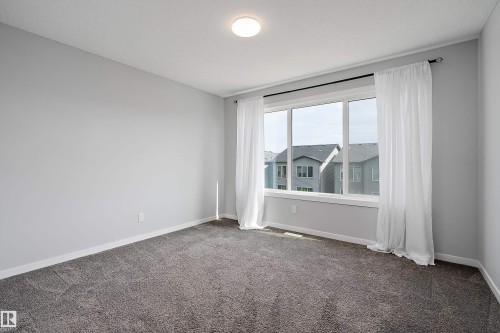 Bright room with gray carpet flooring and light gray walls - 9227 223 Street Nw, Edmonton, AB 