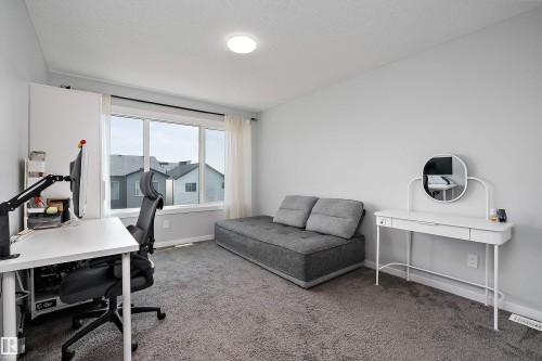 Neutral-toned wall finish, recessed ceiling lighting, multi-panel window, and carpeting - 9227 223 Street Nw, Edmonton, AB 