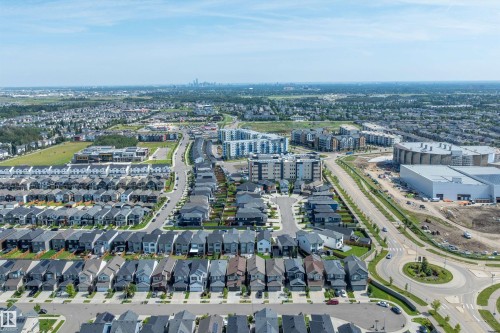 Expansive residential area featuring numerous single-family homes, multi-story residential buildings, paved streets, and a prominent commercial structure - 9227 223 Street Nw, Edmonton, AB 