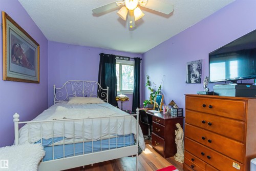 Wood-finish flooring with a ceiling fan light fixture - #6 3819 76 St Nw, Edmonton, AB 