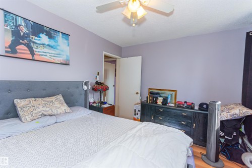 Wood-finish flooring with light purple painted walls and a ceiling fan - #6 3819 76 St Nw, Edmonton, AB 