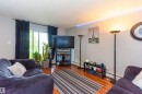 Hardwood-finish flooring, sliding glass door with balcony access, and built-in wall lighting - #6 3819 76 St Nw, Edmonton, AB 
