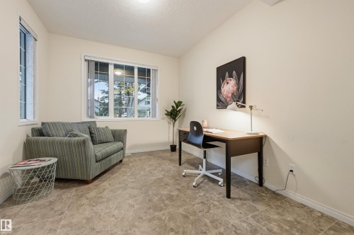 Neutral-toned walls complement the tile-patterned flooring - 7521 111 Avenue Nw, Edmonton, AB 