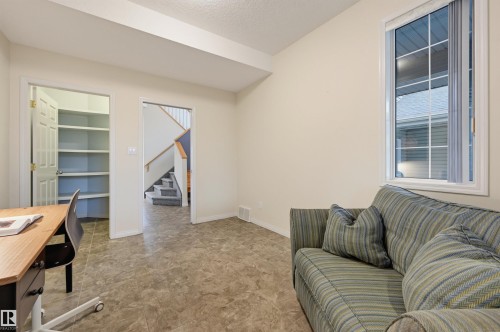 Recessed lighting, tile flooring, built-in shelving, white trim, and a multi-pane window - 7521 111 Avenue Nw, Edmonton, AB 