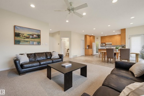 Recessed lighting, ceiling fan, wood-finish cabinetry, built-in microwave, and a white refrigerator - 7521 111 Avenue Nw, Edmonton, AB 