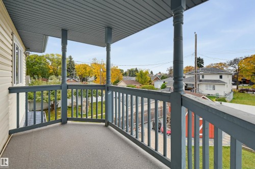 Covered balcony with decorative posts and a textured floor - 7521 111 Avenue Nw, Edmonton, AB 