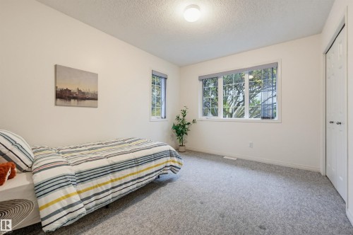 Recessed lighting, light gray carpeting, and white walls with two windows - 7521 111 Avenue Nw, Edmonton, AB 