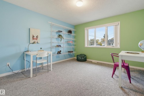 Recessed lighting, large window with white trim, built-in shelving, and light-toned carpeting - 7521 111 Avenue Nw, Edmonton, AB 
