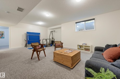 Recessed lighting illuminates the carpeted floor and painted walls - 7521 111 Avenue Nw, Edmonton, AB 