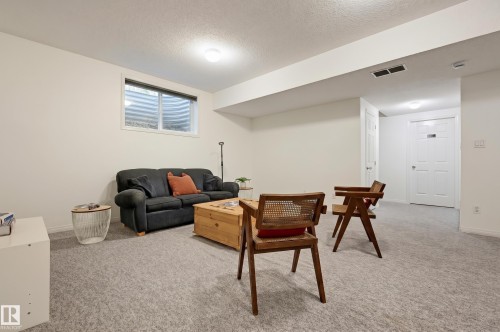 Recessed lighting, light gray carpeting, and multiple doors - 7521 111 Avenue Nw, Edmonton, AB 