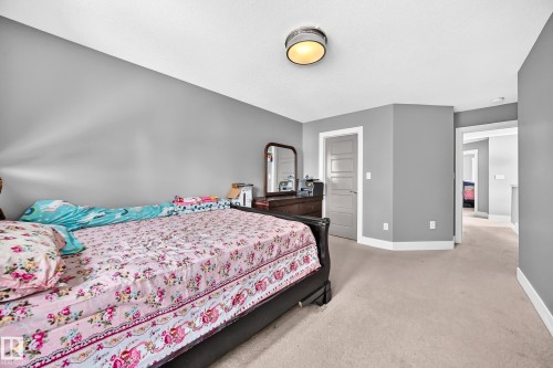 Wall-to-wall carpeting, contemporary light fixture, gray painted walls, and white trim accents - 12730 118 Street Nw, Edmonton, AB 