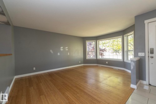 Hardwood flooring, bay window, white trim, and a built-in shelf - 137 Michigan Street, Devon, AB 