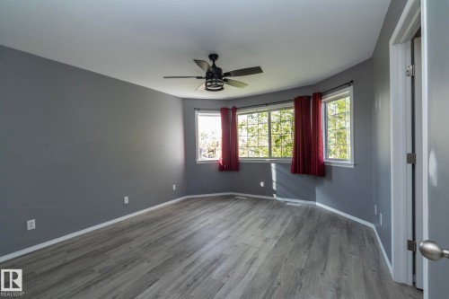 Wood-finish flooring, ceiling fan, and multiple windows - 137 Michigan Street, Devon, AB 
