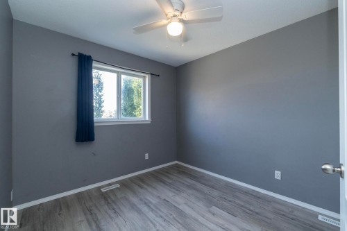 Wood-finish flooring, neutral gray wall paint, and a ceiling fan - 137 Michigan Street, Devon, AB 