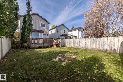 Expansive lawn area with a wood-finish deck and stairs - 137 Michigan Street, Devon, AB 