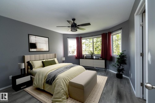 Recessed bay window, ceiling fan, wood-finish flooring, and neutral wall color - 137 Michigan Street, Devon, AB 