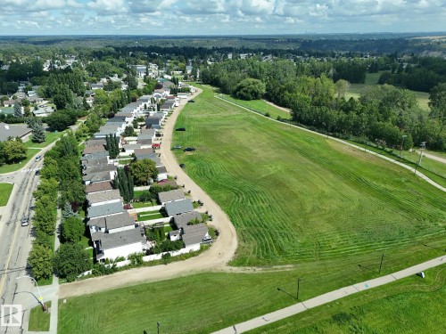 Expansive green spaces bordering residential properties - 137 Michigan Street, Devon, AB 