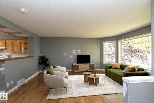 Wood-finish flooring, multiple windows, kitchen pass-through, and neutral painted walls - 137 Michigan Street, Devon, AB 