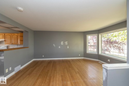 Wood-finish flooring with a bay window feature - 137 Michigan Street, Devon, AB 