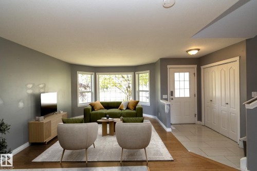 Bay window offering ample natural light, wood-finish flooring, tiled entryway, and a built-in closet with bi-fold doors - 137 Michigan Street, Devon, AB 