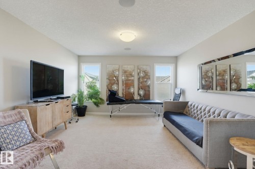 Spacious room featuring light-toned walls, recessed lighting, and three distinct windows - 9448 228 Street Nw, Edmonton, AB 