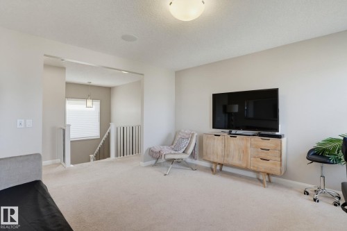 Recessed ceiling speaker, overhead light fixture, carpeted flooring, window with blinds, white baluster railing - 9448 228 Street Nw, Edmonton, AB 