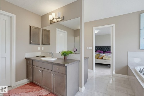 Vanity with integrated sink, sleek countertop, and integrated storage cabinetry - 9448 228 Street Nw, Edmonton, AB 