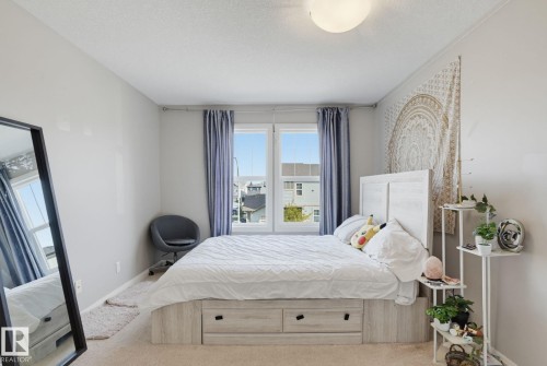 Wood-finish flooring, light-colored walls, and a built-in ceiling light fixture - 9448 228 Street Nw, Edmonton, AB 